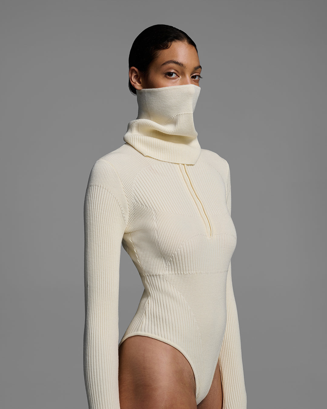 Female model wearing a knit wool buff in alabaster white with matching bodysuit. #color_alabaster