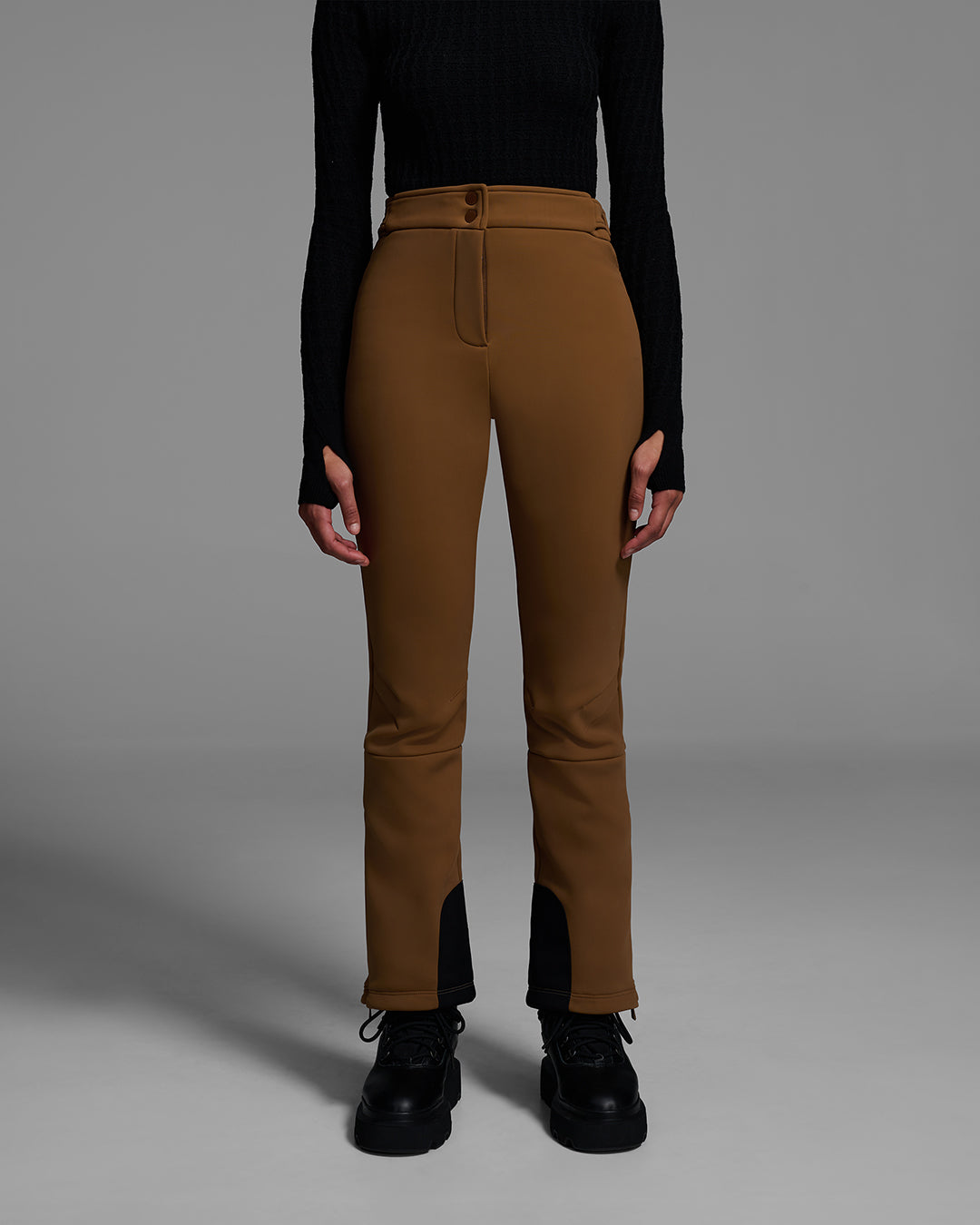 Front view of a woman wearing a 4-way stretch ski pant in sepia brown and a black base layer top. #color_sepia
